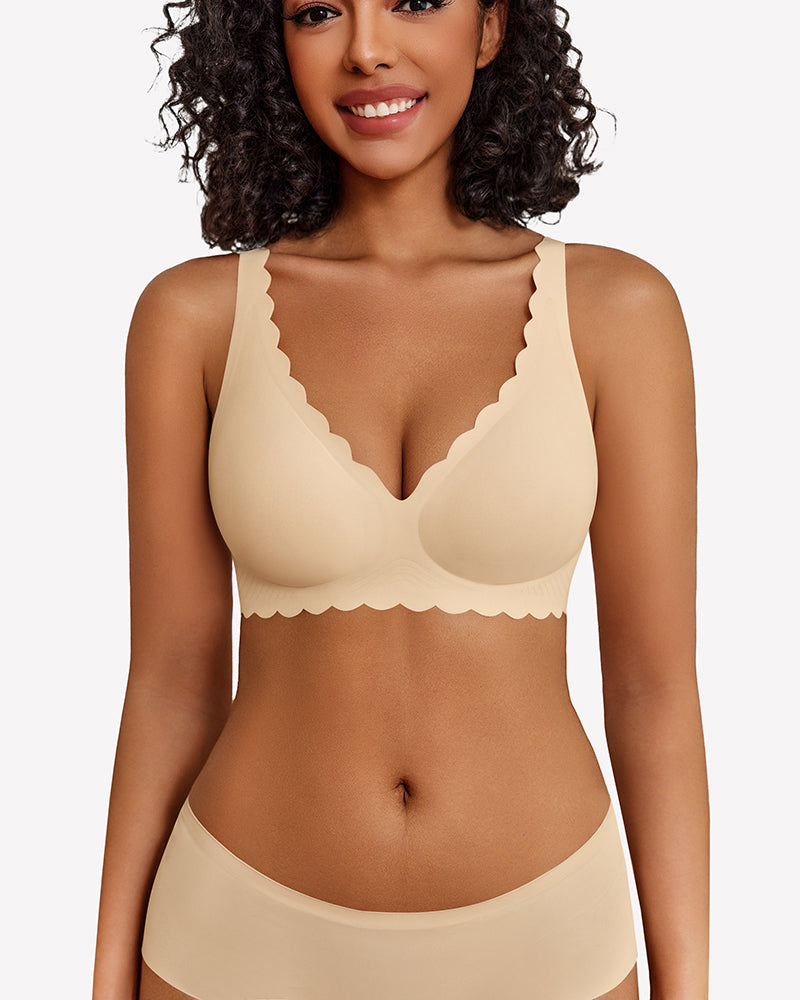 Beige seamless V-neck bra with scalloped edges, full coverage, smooth fabric, worn by a woman.