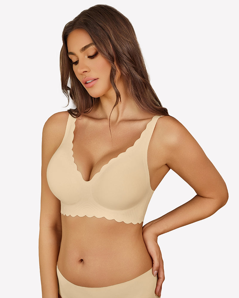 Beige seamless V-neck bra with scalloped edges, full coverage, smooth fabric, worn by a woman