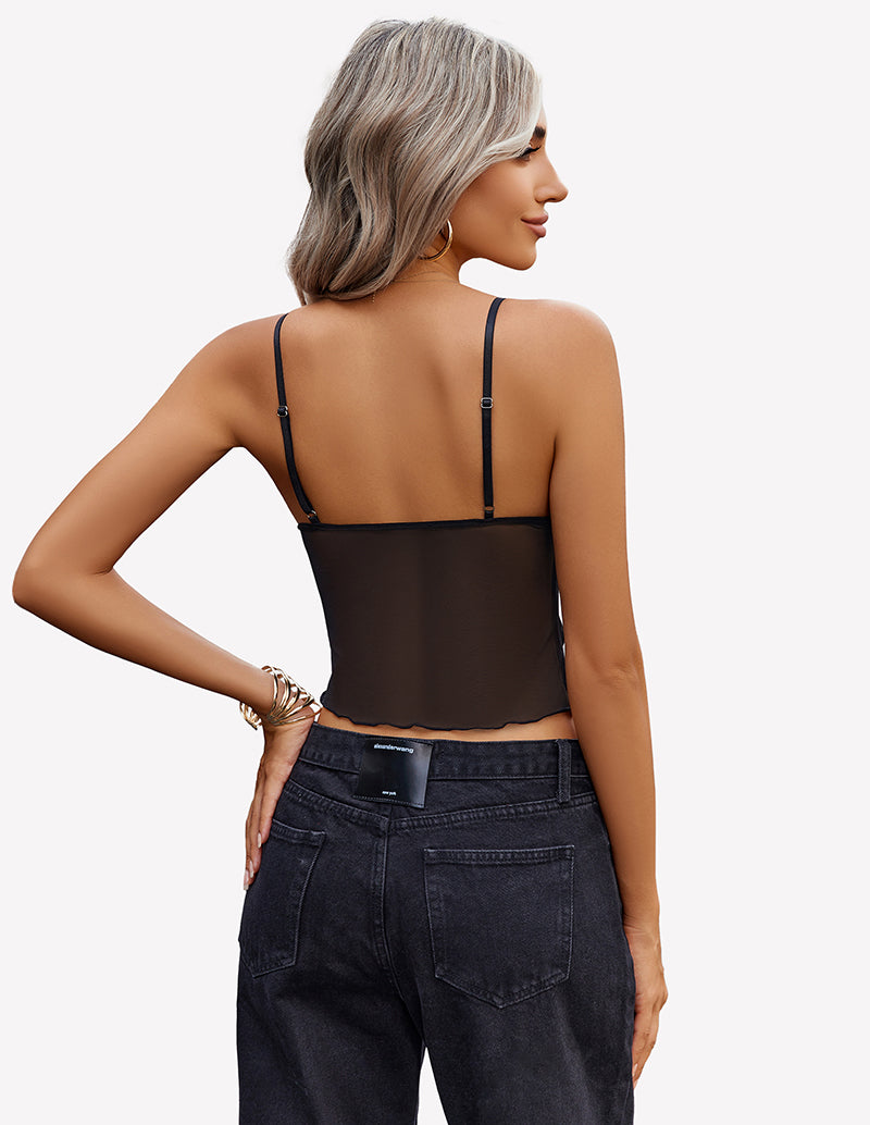 Black mesh crop top with adjustable straps and high-waisted jeans. Y2K summer fashion.