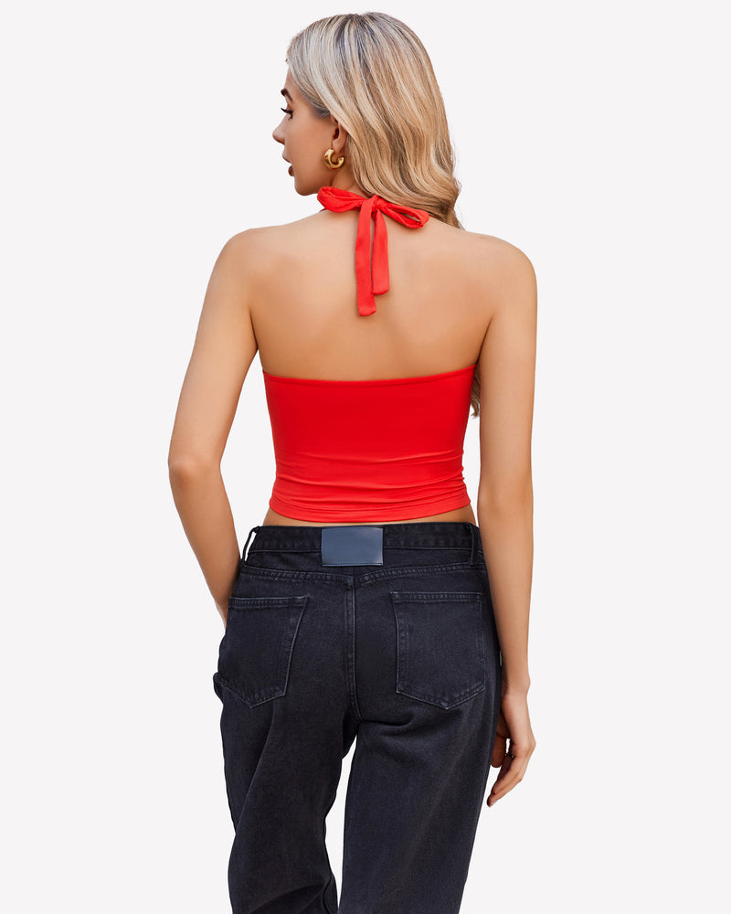 Red halter crop top with backless design, paired with black denim jeans. Perfect for going out.