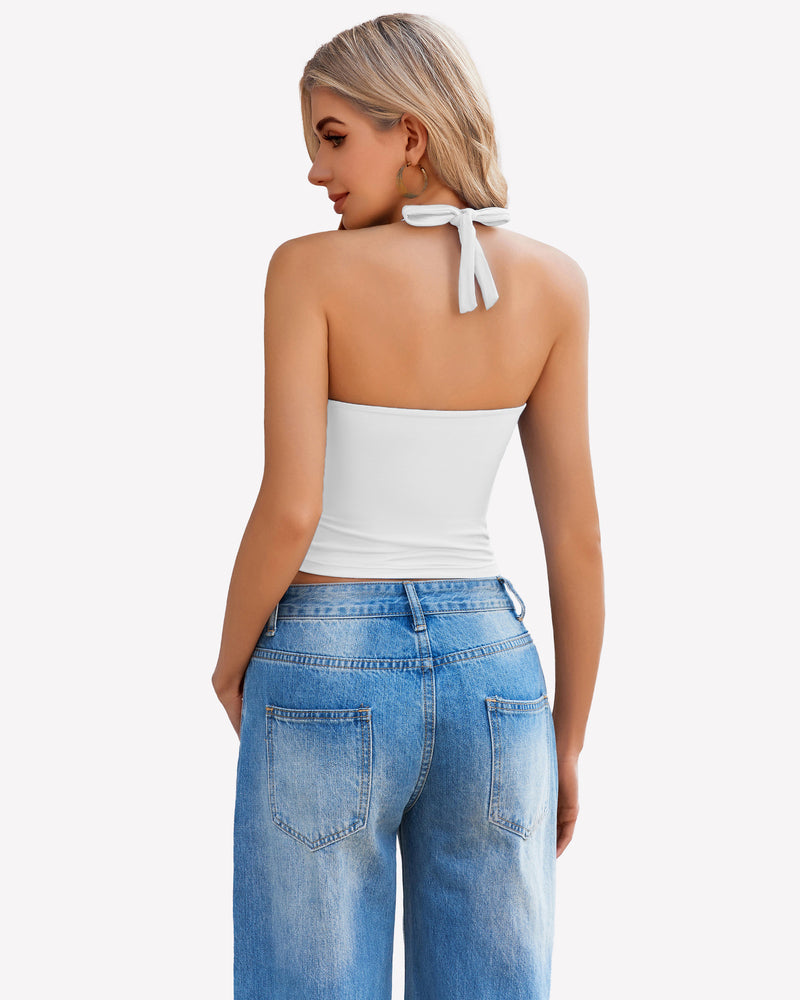 White halter crop top with backless design, paired with blue denim jeans. Perfect for going out.