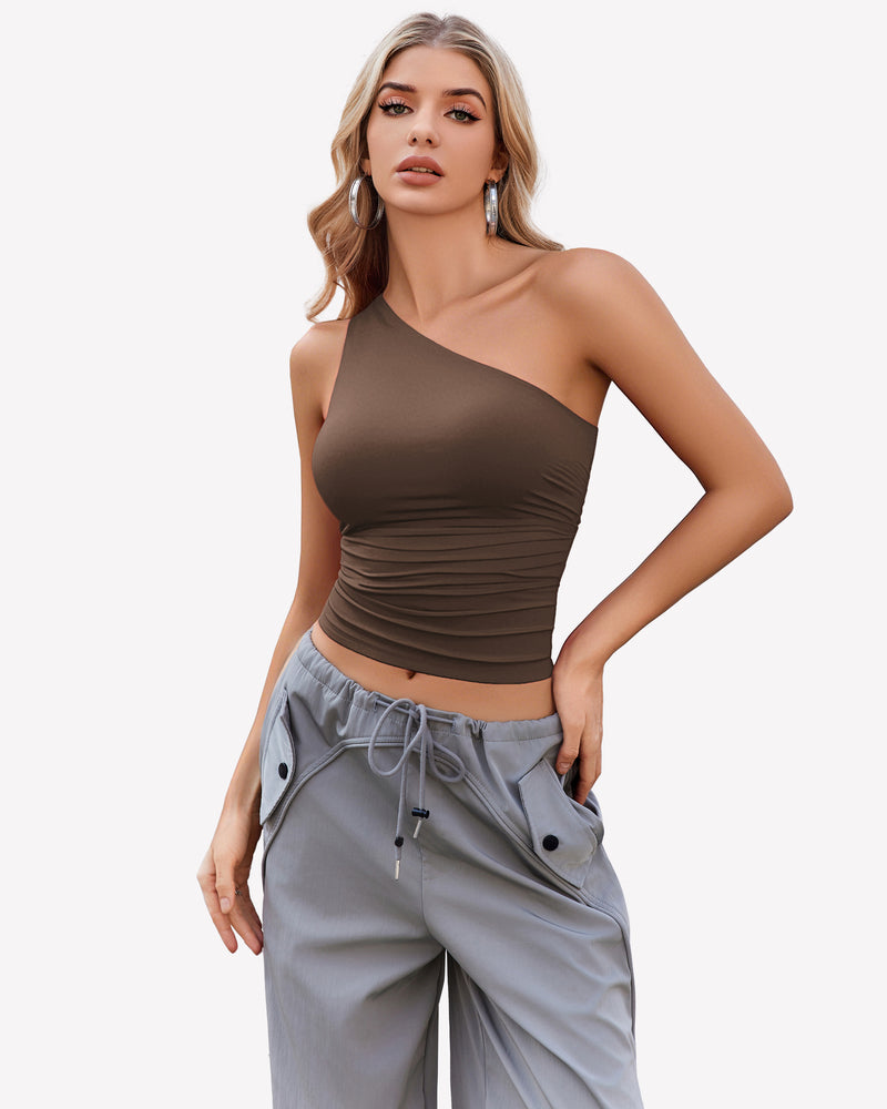 Brown one-shoulder tank top paired with gray pants, a stylish and casual look