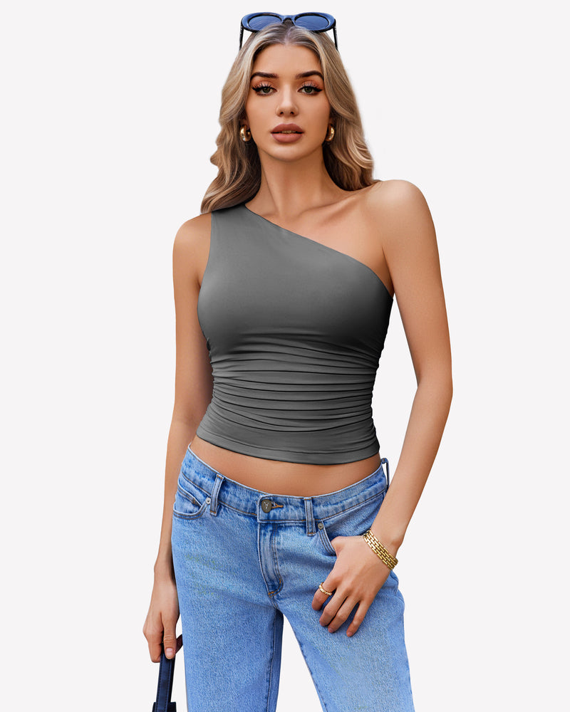 Dark gray one-shoulder tank top with ruched detail, paired with blue jeans. Stylish crop top.