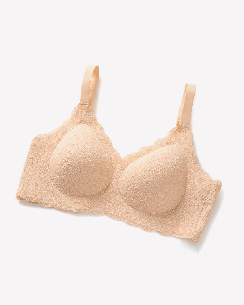 Beige lace wireless full coverage bra with adjustable straps, offering support and coverage.