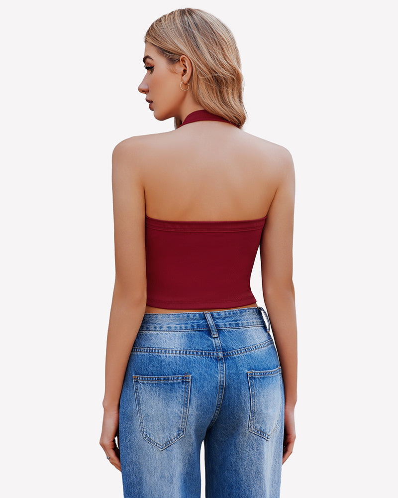 Burgundy backless ribbed crop top with halter neck, paired with jeans, perfect for going out.