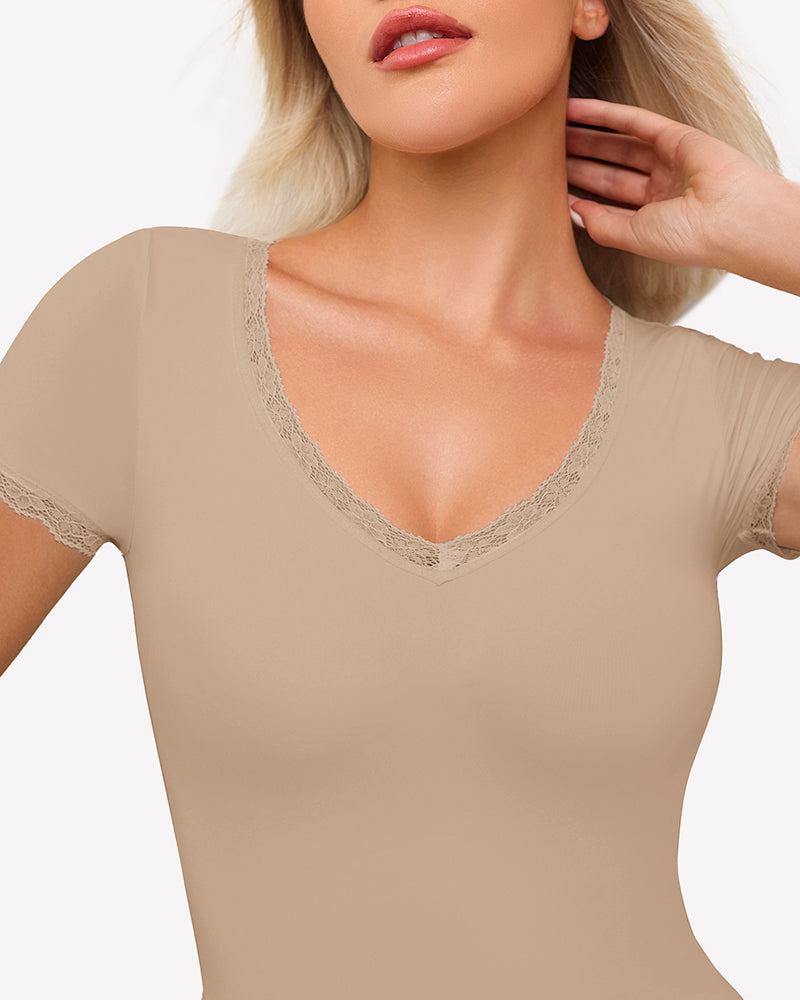 Beige short sleeve V-neck bodysuit with lace trim, offering light smoothing and flattering fit.