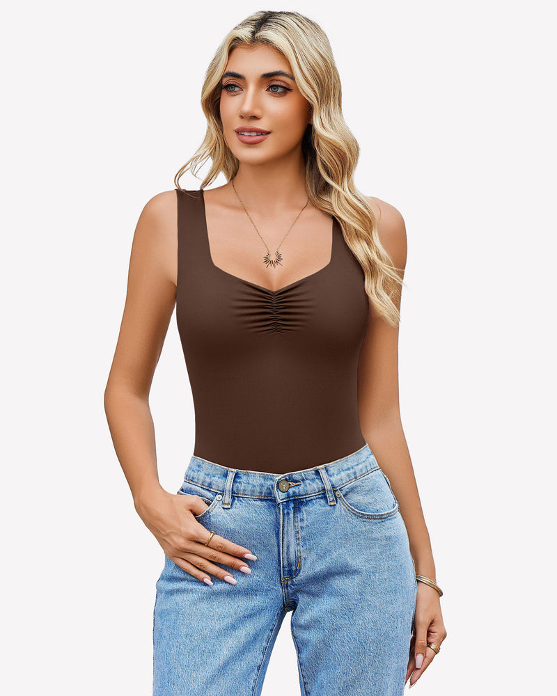 Brown sweetheart neck ruched bodysuit, tank top style, paired with blue jeans. Casual wear.