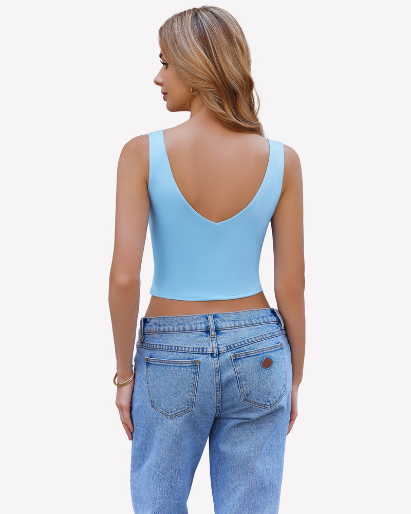 Light blue crop plunge tank top camisole with V-neck and wide straps, paired with light blue jeans.