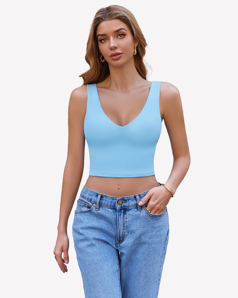 Light blue crop plunge tank top camisole with V-neck and wide straps, paired with light blue jeans