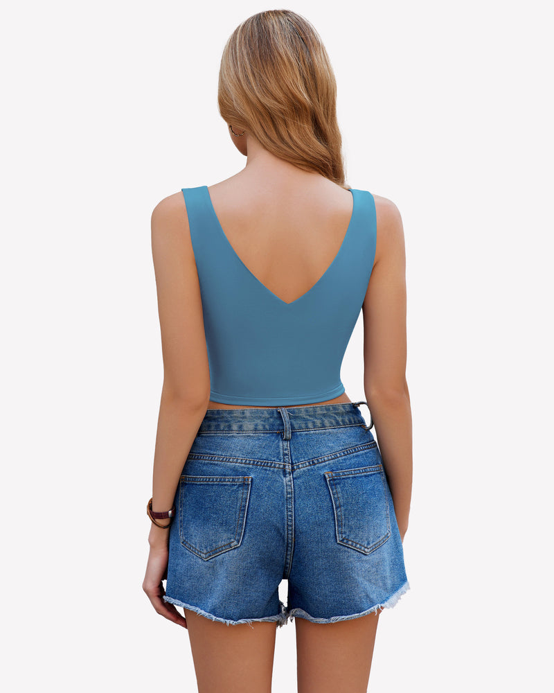 Teal crop plunge tank top camisole with V-neck, wide straps, and denim shorts for a chic look.