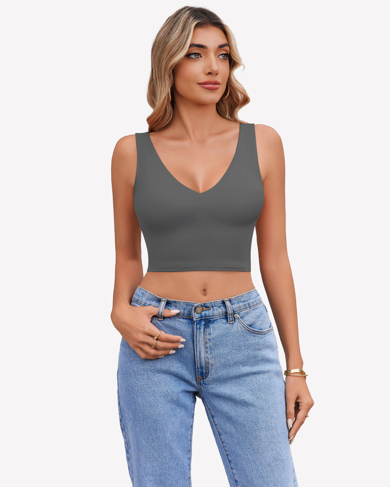 Gray V-neck crop top camisole with wide straps and light blue jeans.
