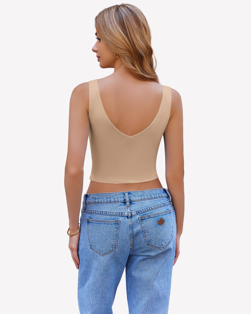 Beige crop plunge tank top camisole with V-neck, wide straps, and blue jeans.