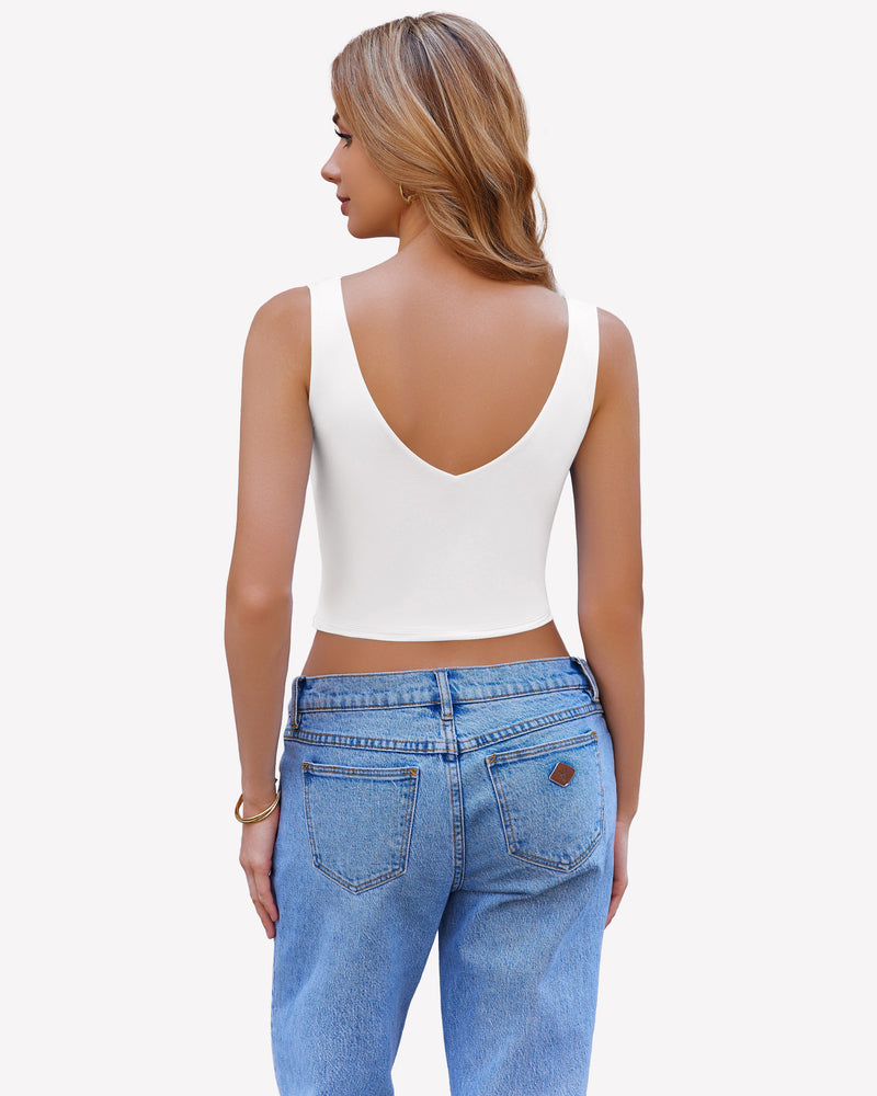 White crop plunge tank top camisole, V-neck, wide straps, and light blue jeans for a chic look.