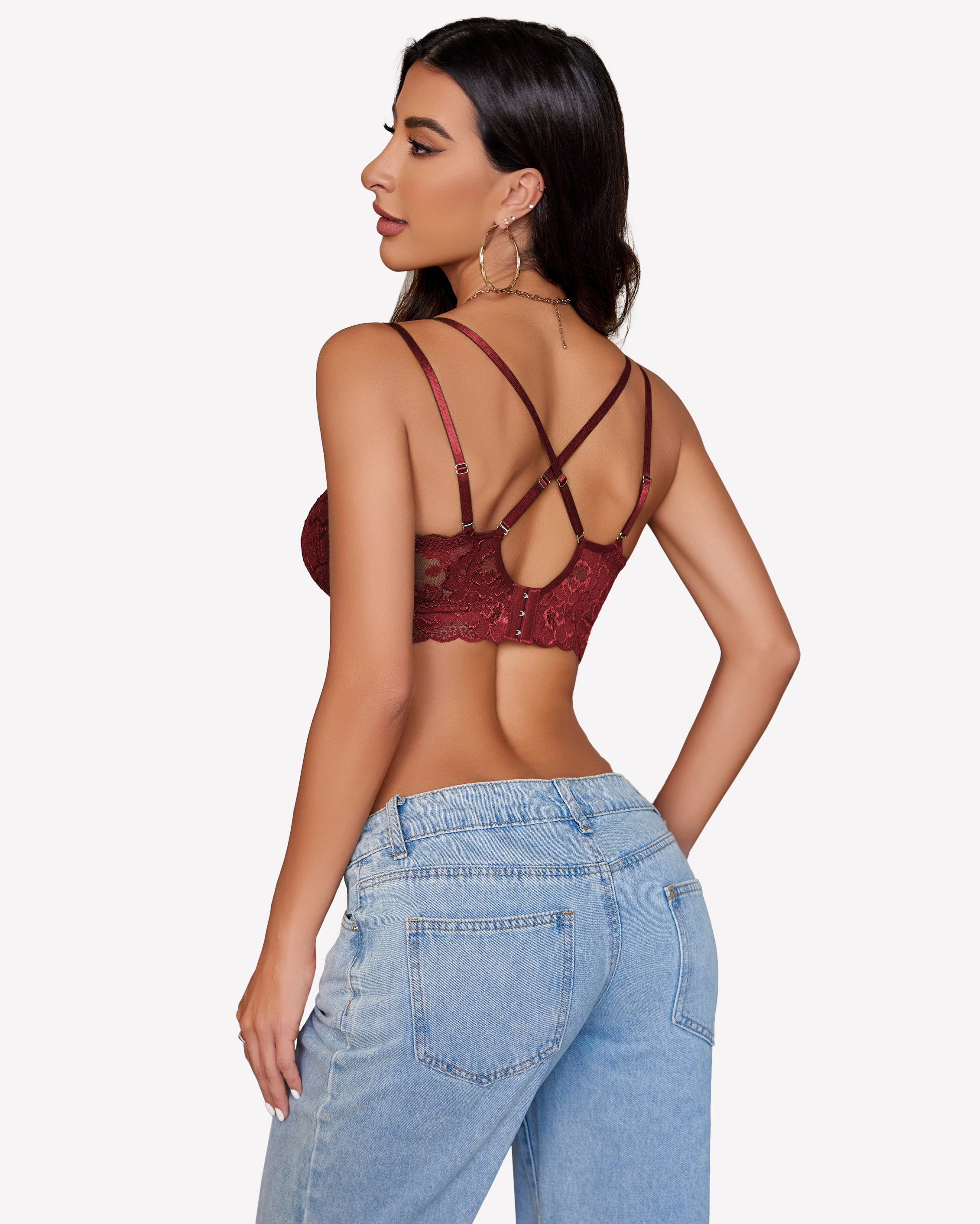 Burgundy floral lace bralette with cross-back design and denim jeans. Sexy lingerie for women.