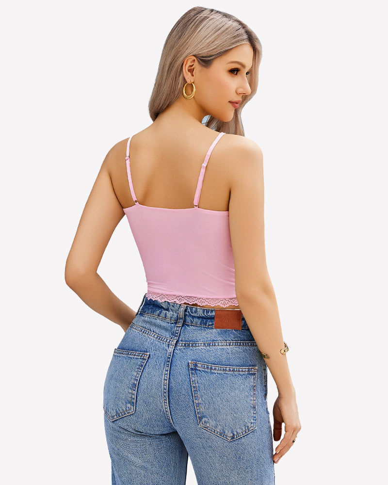 Pink lace cami top with adjustable straps, Y2K style, paired with blue denim jeans. Sexy camisole.