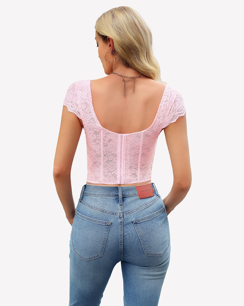 Pink floral lace bustier crop top with cap sleeves, styled with blue jeans. Sexy lingerie for women.