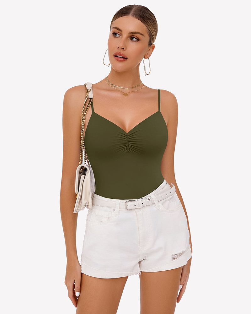 Olive green ruched V-neck thong bodysuit with adjustable straps, paired with white shorts