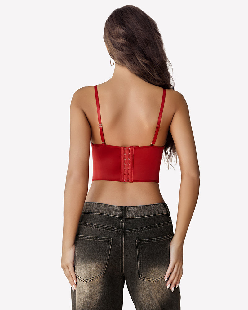 Red bustier top with spaghetti straps and dark-wash jeans. Essential corset top for women.