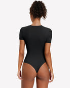 Back view: Black short-sleeve snap bodysuit, fitted one-piece leotard top.