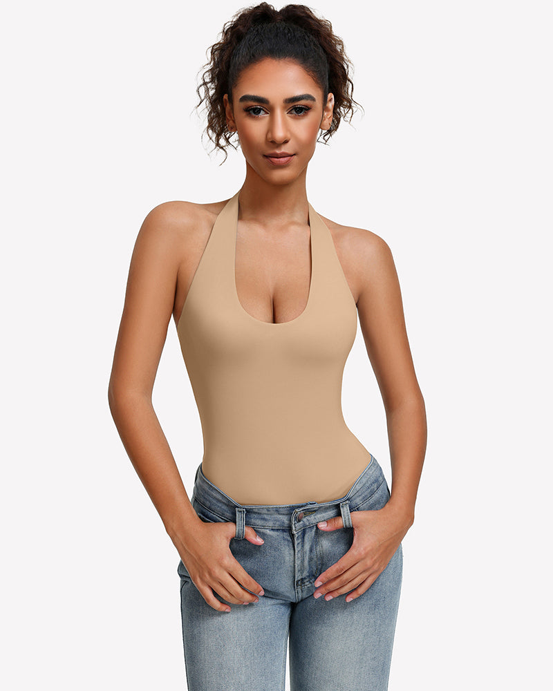 Beige halter bodysuit with deep scoop neckline, worn with blue jeans