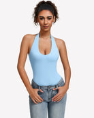 Light blue halter bodysuit with deep scoop neckline, worn with blue jeans