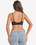 Floral lace underwire bra back view in black with sheer unlined cups and adjustable straps