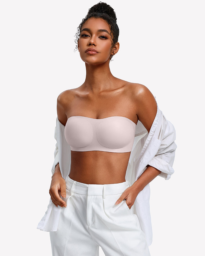 Strapless wireless bra in light pink with smooth molded cups, worn with an open shirt