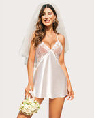 Model in silver satin nightdress with lace cups and plunging V-neckline exuding elegance.