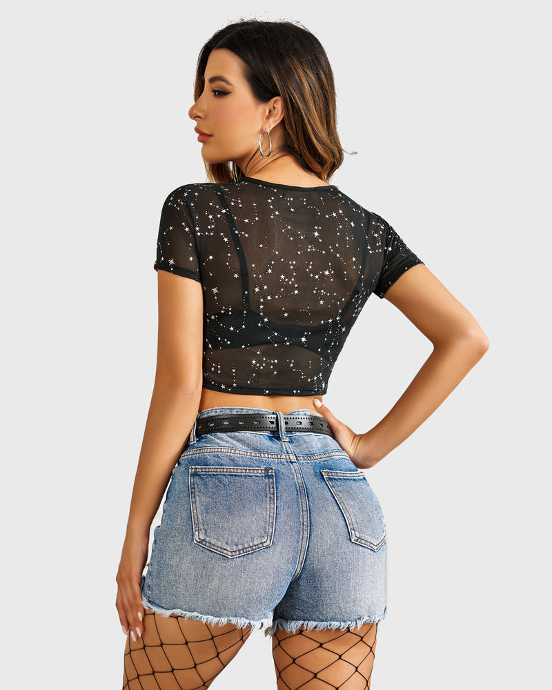 Black mesh crop top with star print paired with denim shorts and belt. Sexy see-through blouse