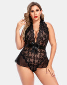 Plus size lace bodysuit with open back and halter neck, featuring satin ribbon ties.