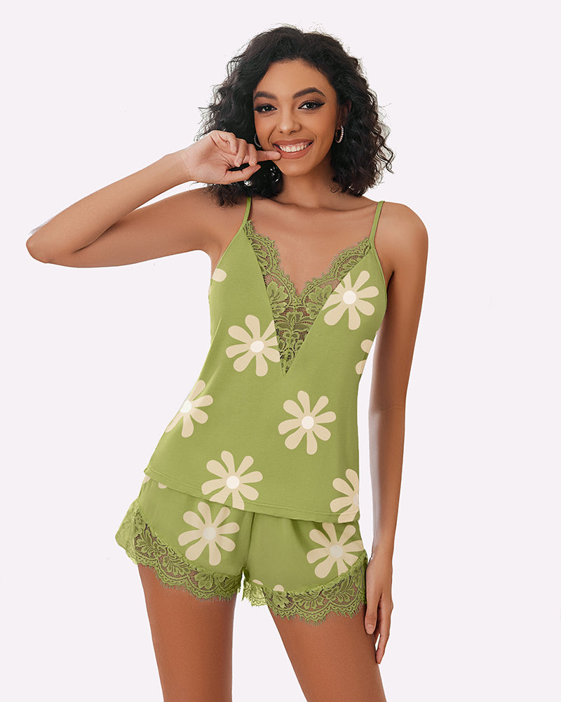 Floral pajama set for women. Green camisole top and shorts with daisy print, and lace trim.