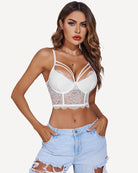 Grey lace bustier top with layered straps, styled with a high-waisted leather skirt.