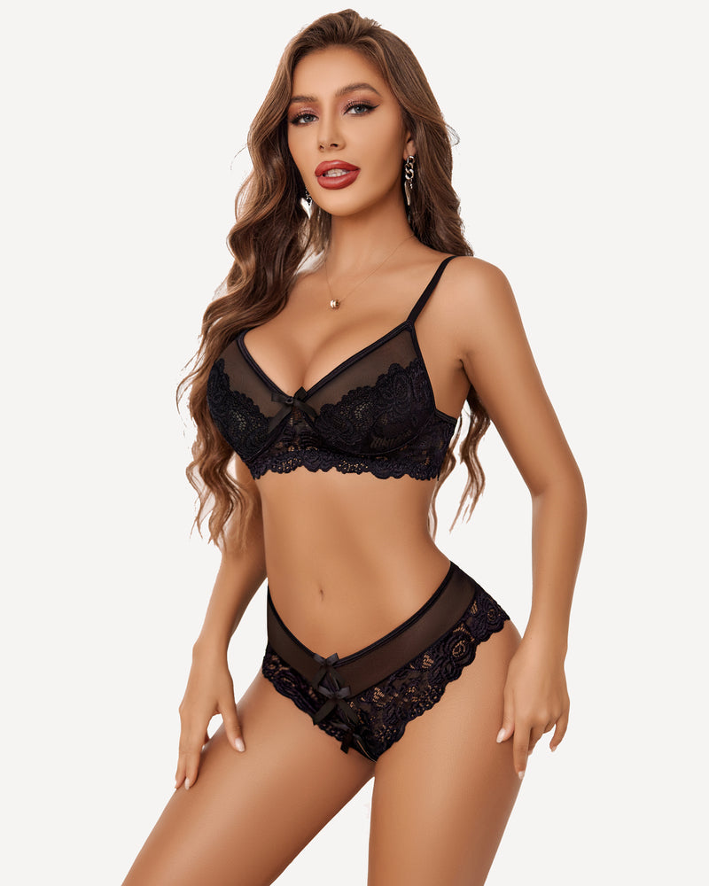 Black lace bra and panty set with floral lace and bow details. Women's sexy lingerie outfit.