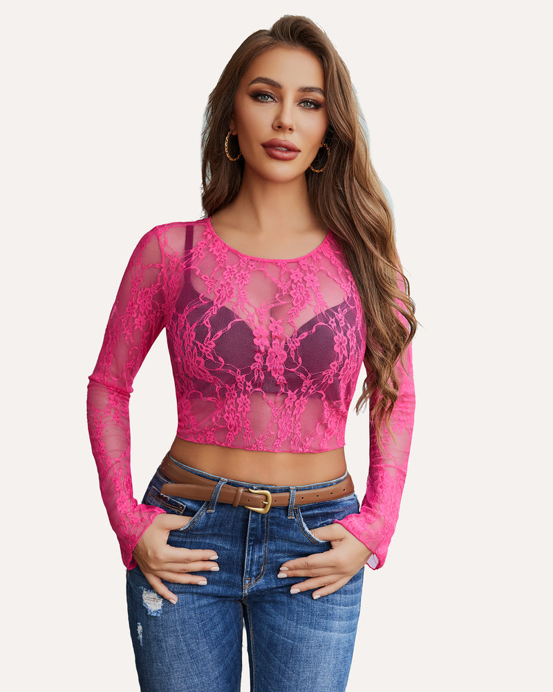 Hot pink floral lace sheer crop top with long sleeves, blue jeans, and brown belt. Classy and sexy.