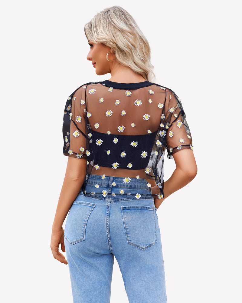 Black mesh daisy crop top with denim jeans. Trendy and sexy see-through shirt for women.