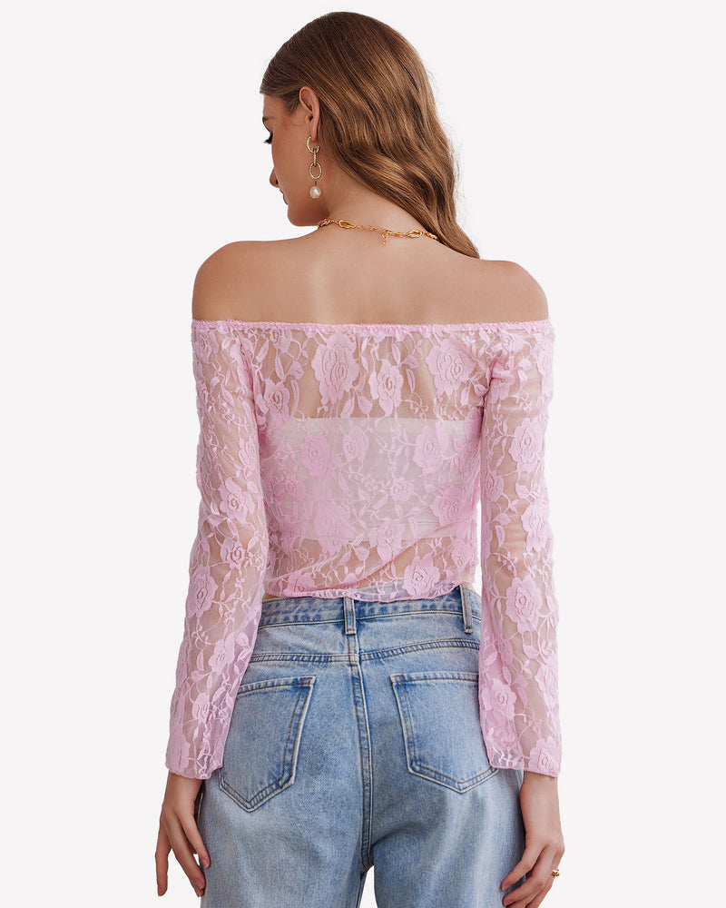 Pink lace mesh Y2k off-shoulder crop top with bell sleeves, floral design, and denim jeans.