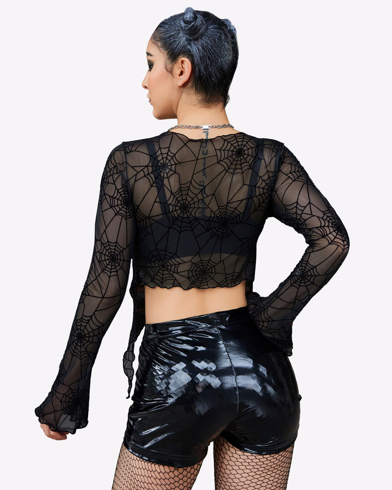 Black spiderweb mesh crop top with tie front, Y2K style, shiny black shorts. Sexy lingerie.