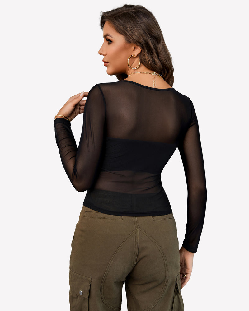 Black sheer mesh crop top with asymmetrical neckline and long sleeves paired with olive cargo pants.