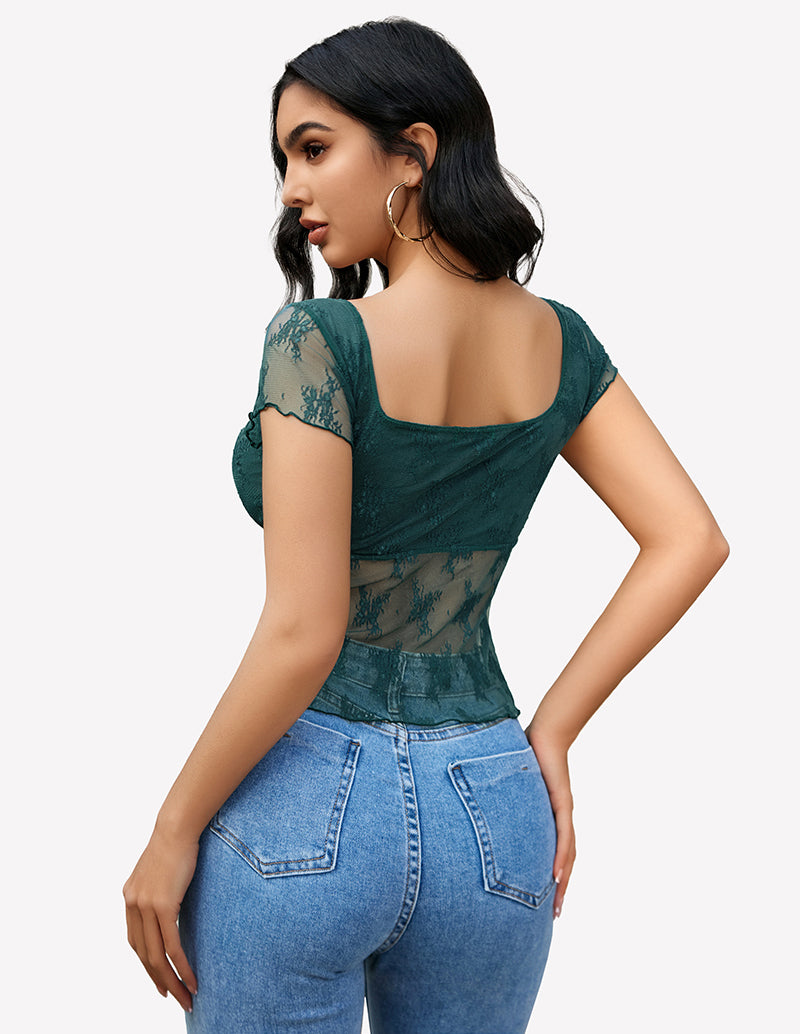 Green lace mesh floral shirt with square neckline and blue jeans. Stylish and elegant.