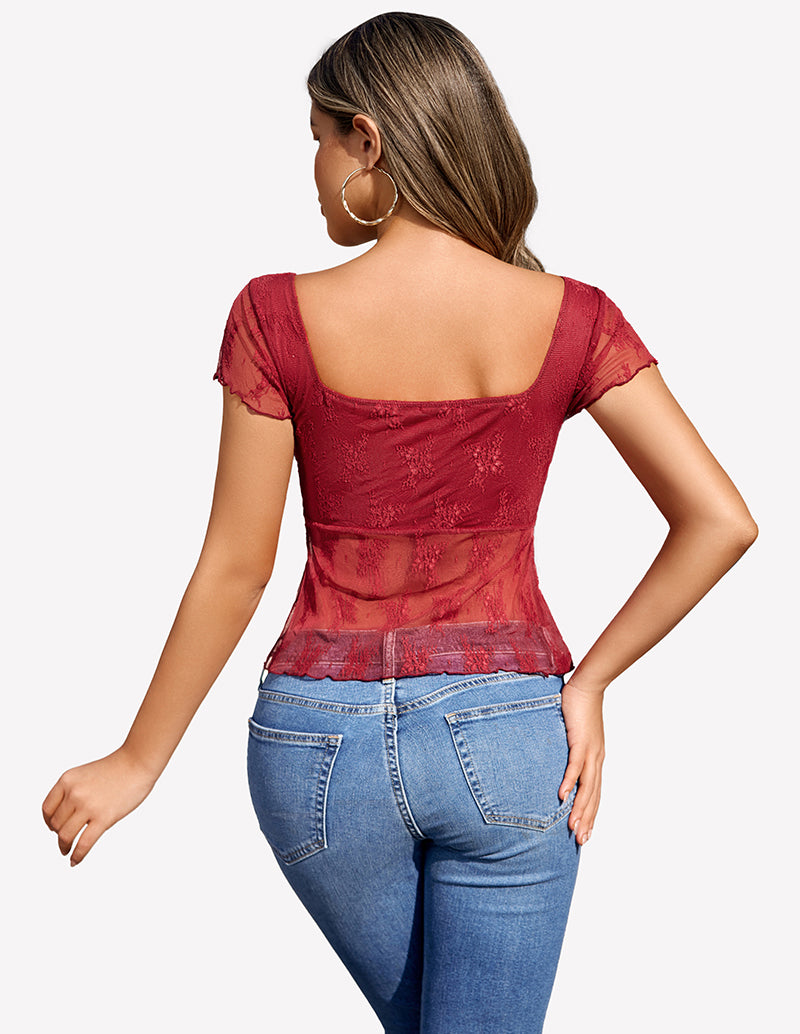 Burgundy lace mesh floral shirt, square neckline, and blue jeans. Fashionable outfit.