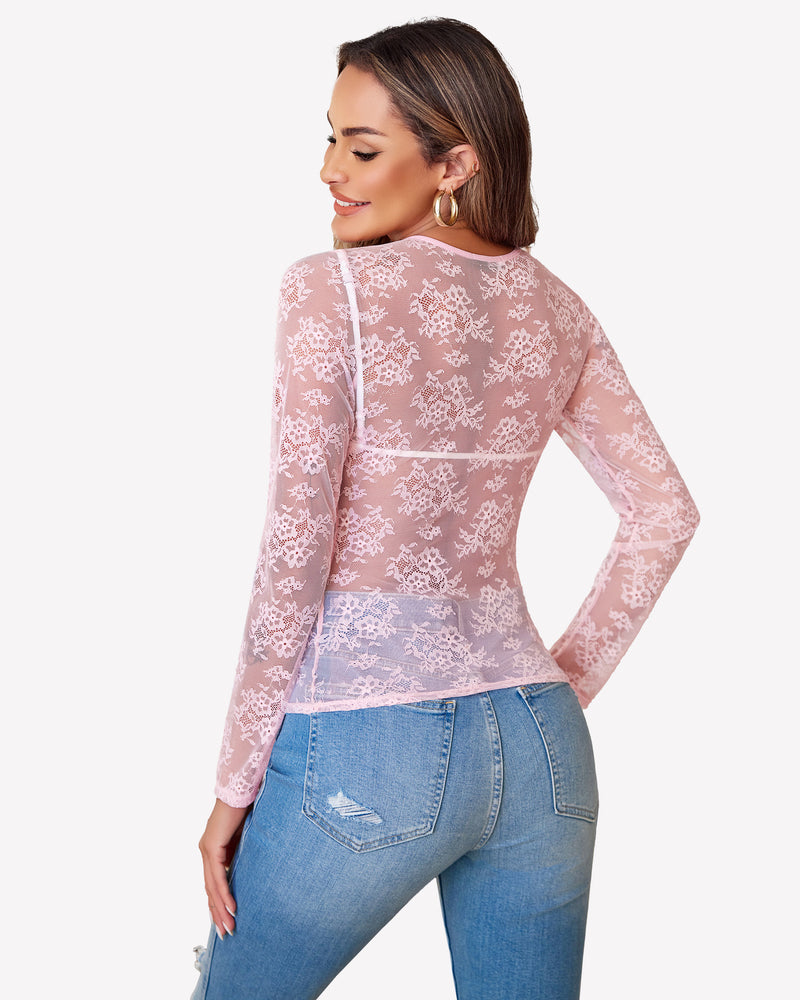 Pink lace mesh top, long sleeves, floral pattern, with blue jeans. Festival wear.