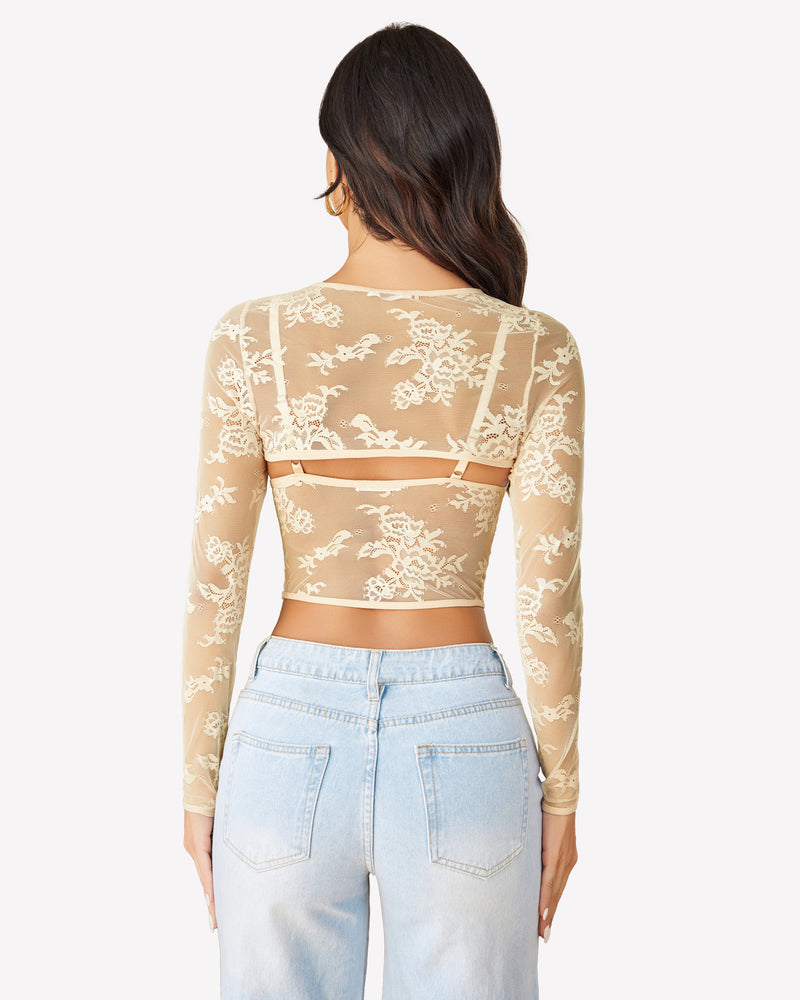 Beige lace long sleeve cami top with floral design and light blue jeans. Sexy lingerie.