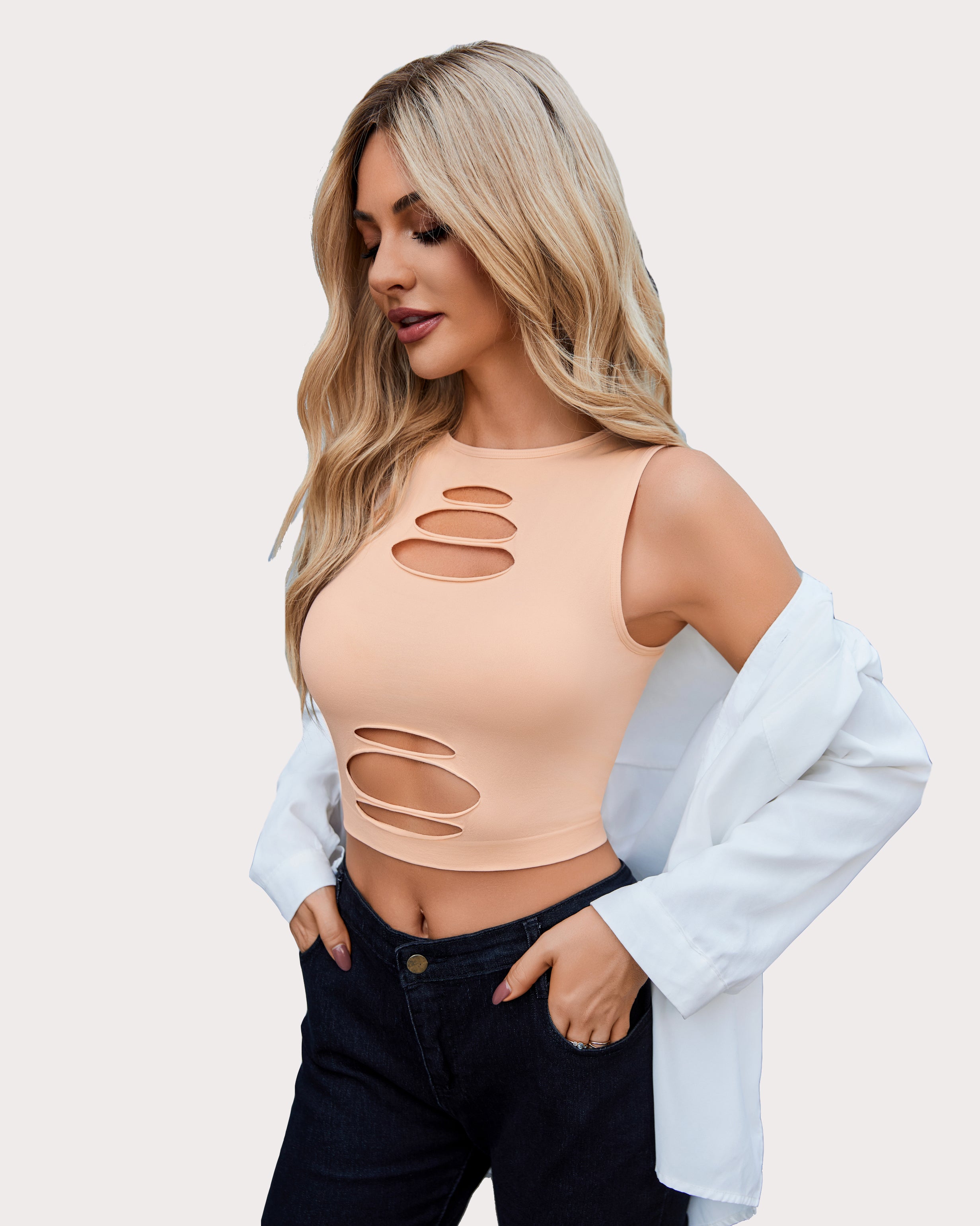 Peach cut-out crop tank top and dark denim jeans, fashionable for women, showing curves.