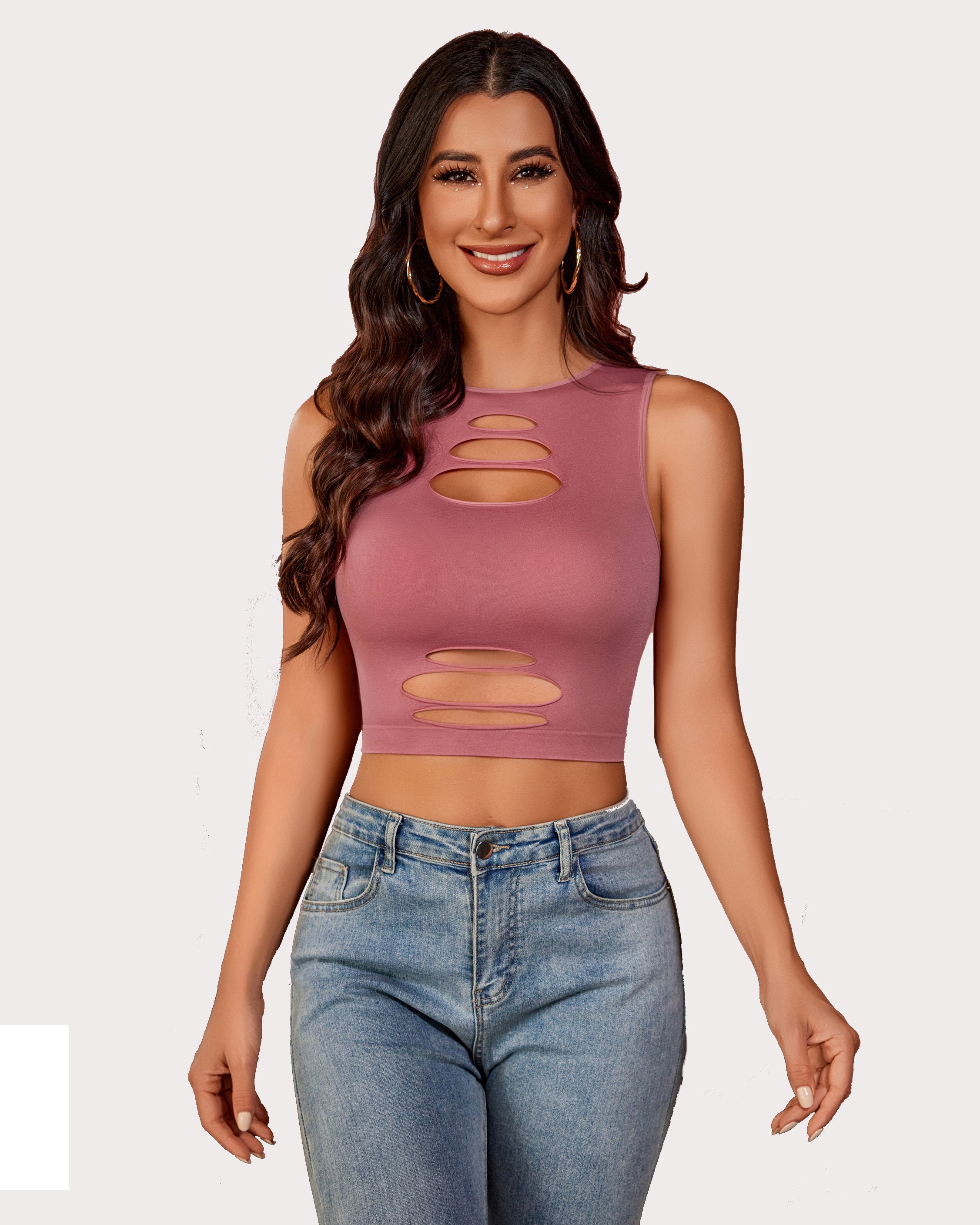 Dusty rose cut-out crop tank top with light denim jeans, showing an attractive curve for women.