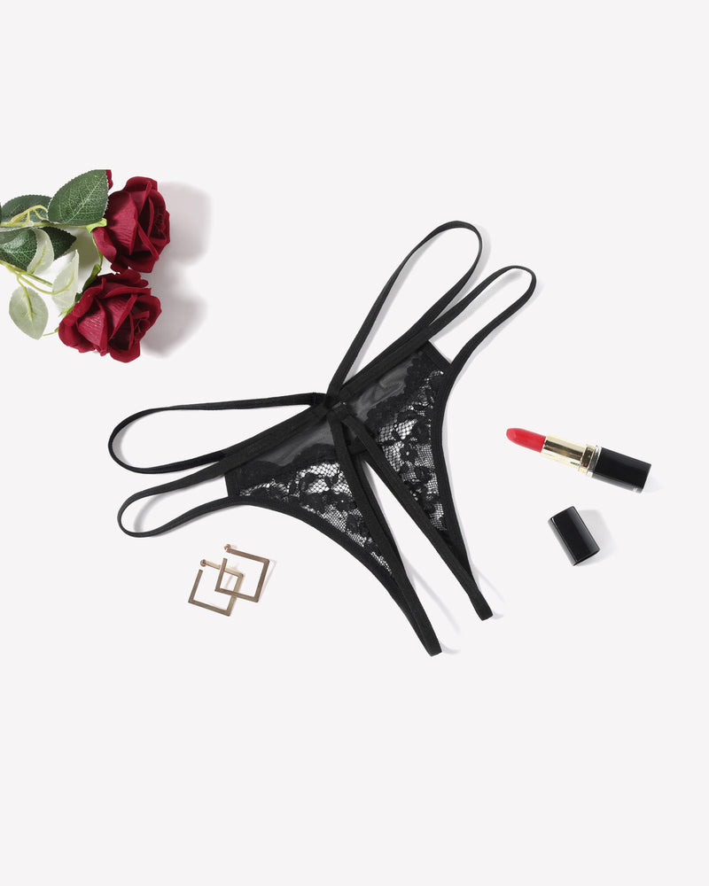 Black floral lace G-string panty with open design, sexy lingerie, red lipstick and roses.