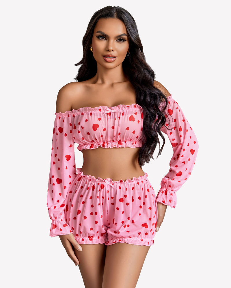 Pink heart-print off-shoulder lingerie set. Ruffle trim, long sleeves, and bow detail.