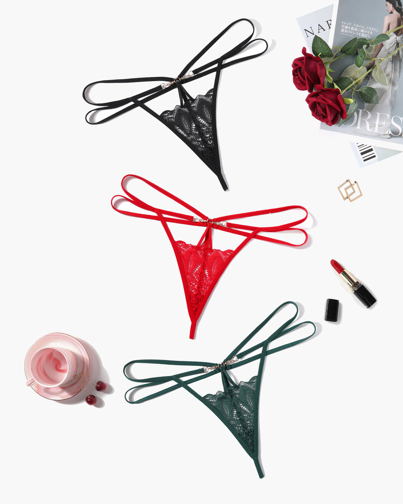 Floral lace thong briefs in black, red, and green with strappy design and gold accents