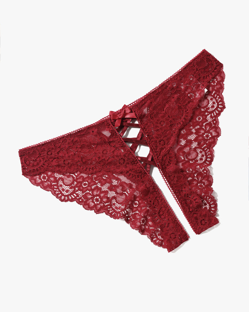Red lace hipster panties with criss-cross straps and bow detail. Floral lace design.