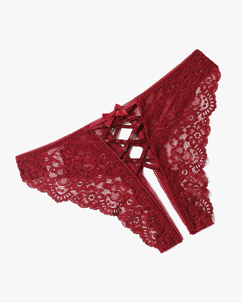 Burgundy lace hipster panties with criss-cross straps and bow detail. Delicate floral lace design.