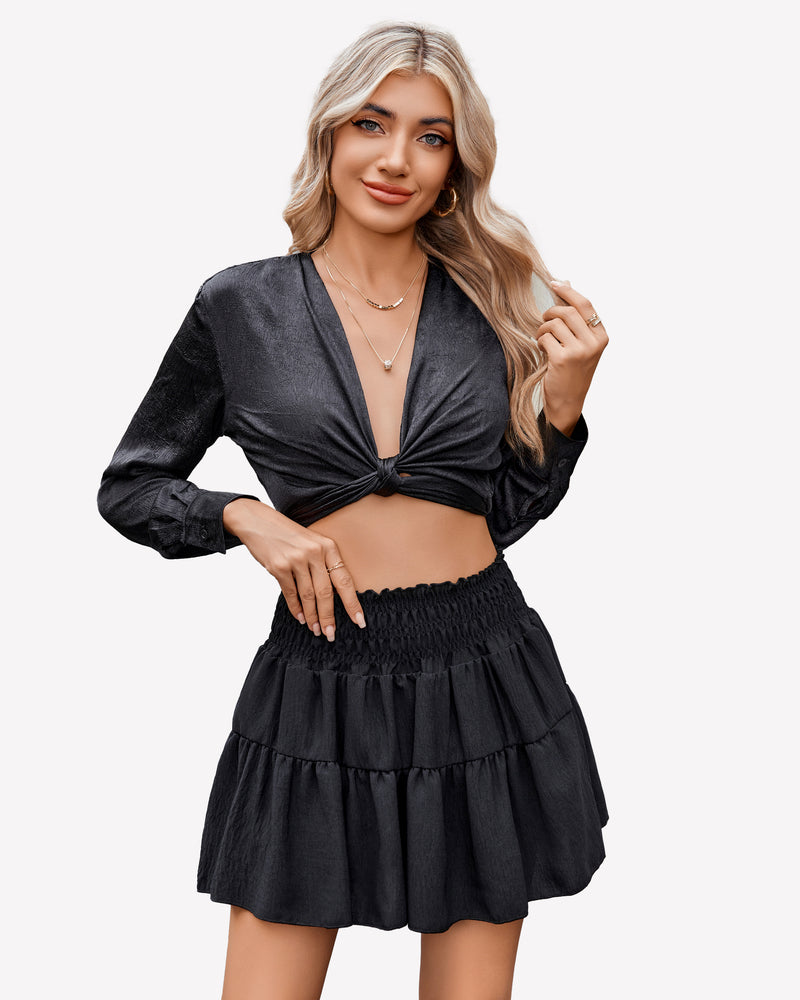 Black flowy A-line short skirt with shirred waist, paired with a black crop top, flattering curve